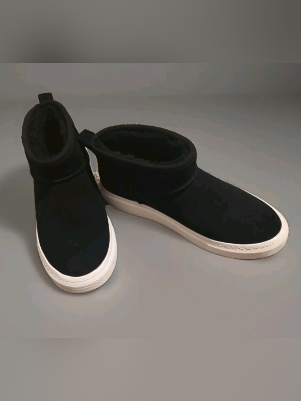 UGG Women's Alameda Mini Boots in black suede with a thick white sneaker sole.